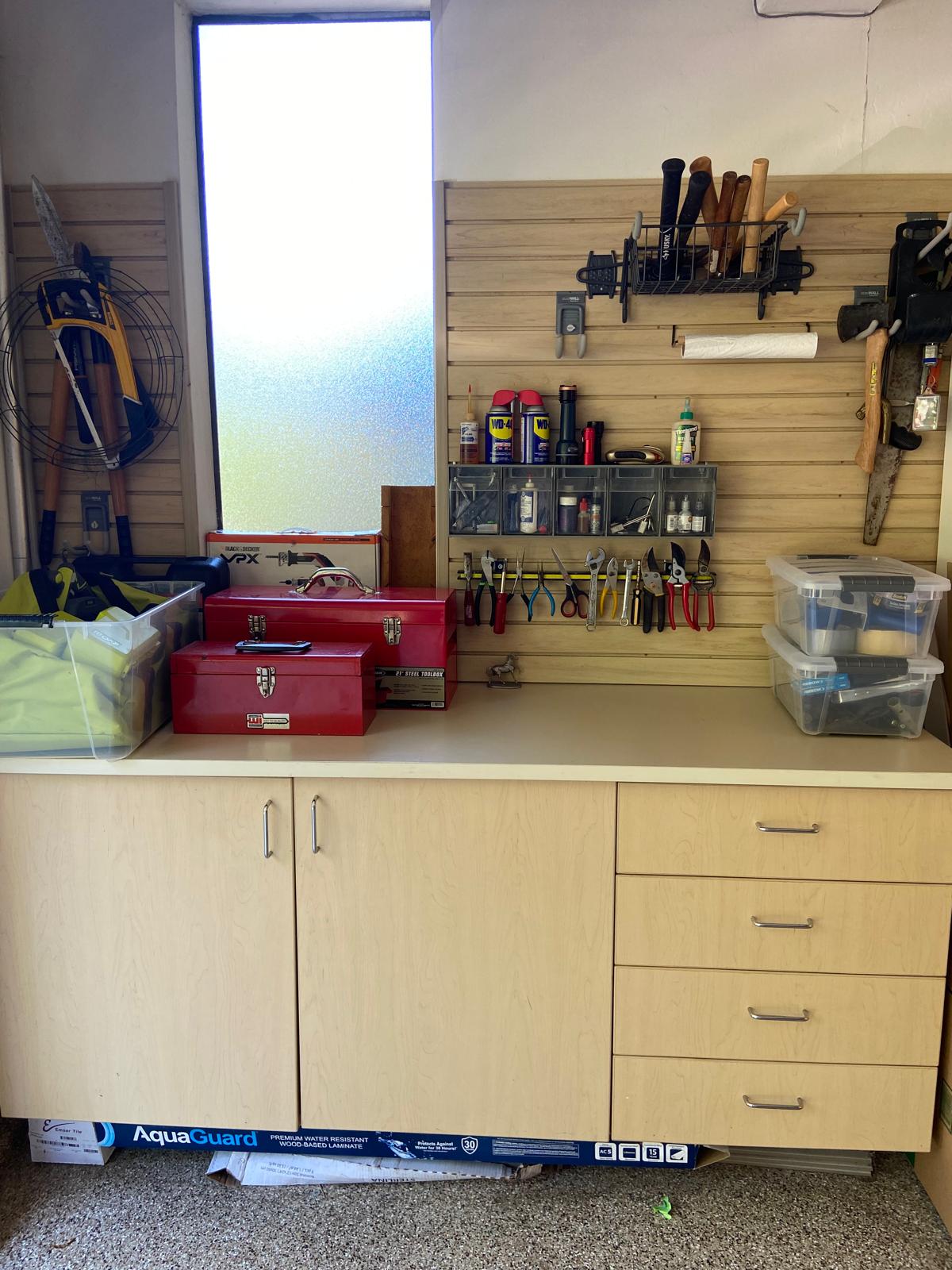 After organization: the garage workbench with arranged tools and a clear counter