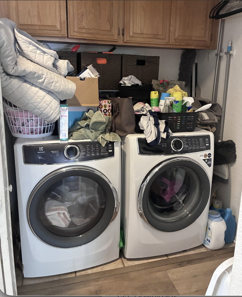 Before organization: laundry and cleaning supplies piled above the washer and dryer