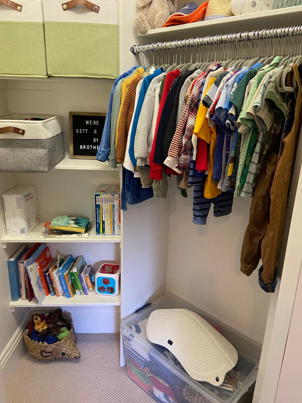 A finished child’s closet with clothing and storage grouped on shelves